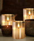 Glass Battery Operated LED Flameless Candles With Remote And Timer Pack Of 3 Real Wax Look Flickering Warm Light Gold on table