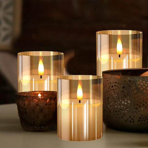 Glass Battery Operated LED Flameless Candles With Remote And Timer Pack Of 3 Real Wax Look Flickering Warm Light Gold on table