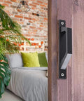 Side view of black 7.9 inch sliding barn door handle on wooden door, ideal for barn doors gates cabinets closets farmhouse decor multifunctional