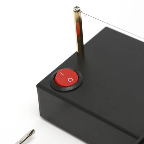 Close-up of Electric Ribbon Cutter And Sealer With Adjustable Heat Range from 100 To 600 Degrees, showing power switch and wire.