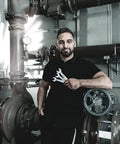 Mechanic holding Joker 11 Piece Combination Wrench Set for Tight Spots with Slim 15 Degree Ring Side in industrial setting.