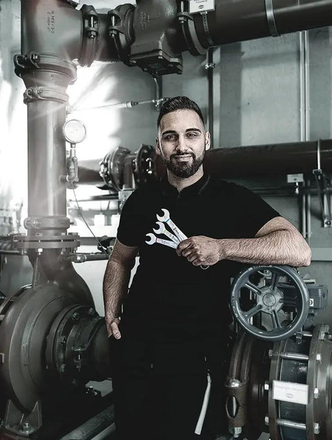 Mechanic holding Joker 11 Piece Combination Wrench Set for Tight Spots with Slim 15 Degree Ring Side in industrial setting.