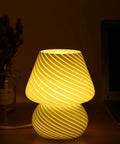 Yellow Glass Mushroom Bedside Lamp With Vintage Murano Stripe Compact Nightstand Desklamp For Cozy Home Decor Bedroom Living Room Gift Idea Warm White LED Glow, hand-blown striped glass lamp on bedside.