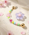 Pastel Jelly Daisy Flower Shoe Charms Set With Glossy Bling Floral Buckles, colorful resin flower charms on a light fabric background.