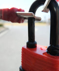 Colored Waterproof Padlocks Set With Keyed Alike Locks, red lock in focus, laminated steel construction, in outdoor setting.