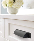 Rochdale Matte Black Cup Pull 3-3/4 Inch Center To Center Pack Of 10 Durable Zinc Cabinet Drawer Pulls installed on white drawer