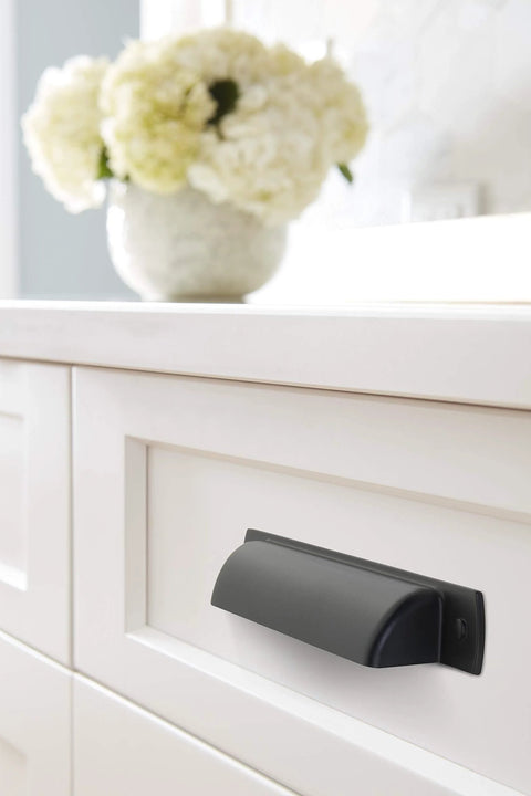 Rochdale Matte Black Cup Pull 3-3/4 Inch Center To Center Pack Of 10 Durable Zinc Cabinet Drawer Pulls installed on white drawer