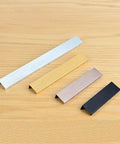 Hidden Cabinet Handles Set Of 2 Heavy Duty Aluminum Finger Pull And Tab Pull For Kitchen Cabinets, shown in four colors on wood surface