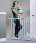 Woman holding child beside Essential Stairway and Walkway Baby Gate for Stairs and Doorways, Hardware Mounted, 30 Inch Tall, White