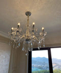 Modern Crystal Ceiling Pendant Light With Polished Chrome Frame And E14 Bulb Socket For Killer Kitchen Island Ambiance Or Cozy Living Room Glow That Truly Slaps Vibe Upward hanging from the ceiling with crystal accents.