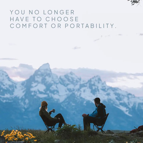 Two people sitting on Go To Ultra Lightweight Camping Chair For Outdoors Easy Fold Portable Lawn Chair with mountains in background.