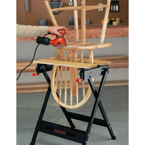 Pro-Grade Portable Workbench With 350-Pound Capacity in use, clamping a wooden chair for sanding in garage workspace