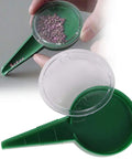 Spreader Seed Planter for Gardens and Farms, Manual Seed Seeder Tool showing green and clear plastic design with seeds