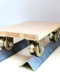 Rock Solid Heavy Duty V Groove Sliding Gate Roller With Beefy Bracket 45 Steel Industrial Track Wheel on metal track and wood platform.