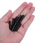 Hand holding a selection from 24 Pack Shelf Support Pins With Rubber Covers, Black Carbon Steel Dowel Pegs For Cabinets, Bookshelves, And Furniture Partitions.