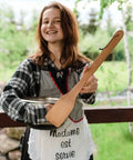 Person holding Monster 18 Inch Wooden Stir Paddle for Crawfish Boil, showing solid natural wood and loop for hanging