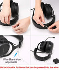 Hands adjusting wire rope on black headphones attached to retractable display security cable lock.