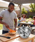 Person using Stainless Steel Food Mill With Three Milling Discs, Hand Crank Rotary Action, Silicone Handle in backyard setting.