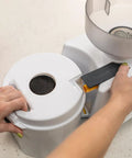 Person using Beefy 1200W High Speed Electric Grain Mill For Fresh Flour Compact Impact Grinder With Stainless Steel Milling Heads
