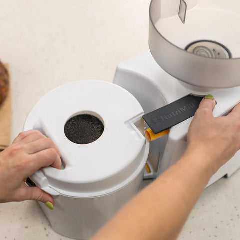 Person using Beefy 1200W High Speed Electric Grain Mill For Fresh Flour Compact Impact Grinder With Stainless Steel Milling Heads