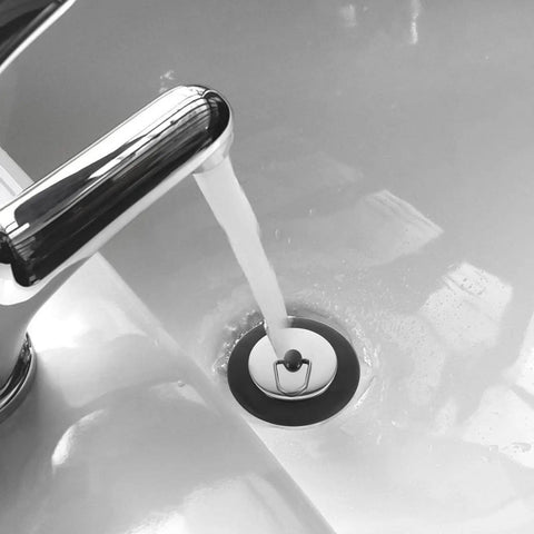 Rubber Bathtub Drain Stopper Plug with Stainless Steel Seal in bathtub with water flowing, showcasing installation and functionality.