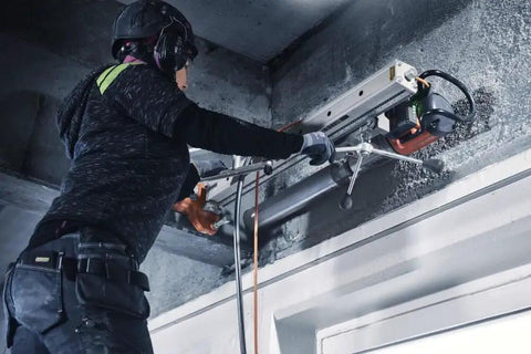 Person using Straight Up Kickass Core Drill And Stand With 4.29 Hp Motor Three Speed Gears for concrete drilling.