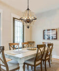 21-Inch Farmhouse Chandelier With 6-Light Rustic Wood Light Fixture For Dining Room, hanging over dining table in warm brown finish.