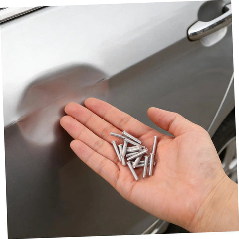 Grab 50 Durable Metal Panel Pulling Studs For Auto Body Work. Silver welding pins in hand for car dent repairs.