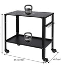 Heavy Duty Welding Table 36 By 18 Inches With A Rock Solid 1200 Lb Capacity Machined Steel Top And Five Eighths Inch Grid Holes Portable Shop Workbench With Brake Casters Built Tough featuring kettlebells on a sturdy cart.