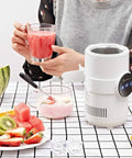 Sharp Two In One Electric Cooling Cup And Slim Desktop Beverage Chiller with a drink and fruit on a table.