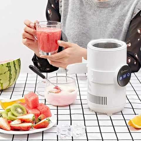 Sharp Two In One Electric Cooling Cup And Slim Desktop Beverage Chiller with a drink and fruit on a table.