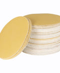 100 Packs Hook And Loop Sanding Discs With Premium Aluminum Oxide Grit For Fast Replacement No Hole Needed stacks of yellow sanding discs