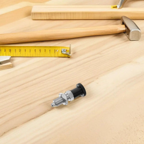 M10 Stainless Steel Reset Indexing Plunger Rock Solid Spring Locking Pin on wooden surface with measuring tape and tools.