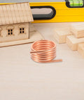 RC Boat Water Cooling Ring Kit For Brushed Motors Copper Cooling Jacket in workshop with wooden model house and tools.