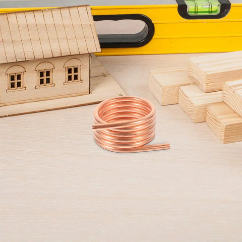 RC Boat Water Cooling Ring Kit For Brushed Motors Copper Cooling Jacket in workshop with wooden model house and tools.