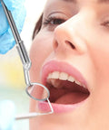 Using LED Lighted Stainless Steel Mouth Mirror For Teeth Inspection And Plaque Removal during an oral check