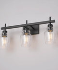 3-light vanity fixture from 5-Piece All-In-One Matte Black Bathroom Set with seeded glass shades for a sleek modern industrial vibe.