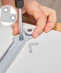 Hand installing 100-Piece Stainless Steel L-Shape Corner Bracket Set for 2x2 Inch Small Angle Joints on cabinet