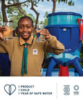 Child holding glasses of clean water near blue filtration system outdoors, promoting safe water access initiative.