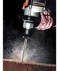 Knockout Impact Drill Packing 810 Watts And A Beefy 13 Mm Chuck Featuring Variable Speed Control drilling into masonry.
