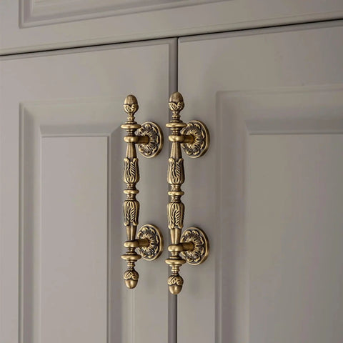 Five Pack Antique Brass Cabinet Handles With 3.4 Inch Hole Centers (107 Mm) Old School Vintage Drawer Pulls installed on cupboard