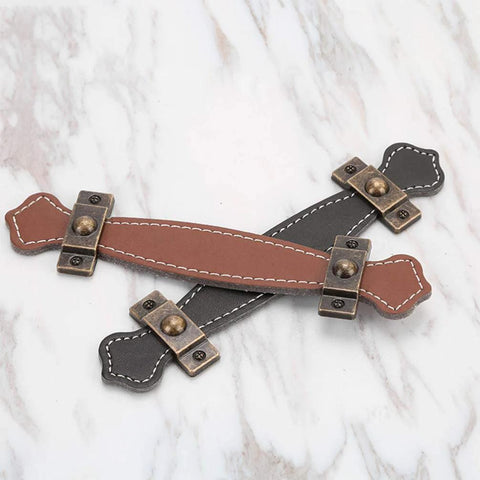 Two Pack Vintage Style PU Leather Cabinet Handles Zinc Alloy Drawer Pulls with smooth grip, brown and black leather on marble surface.