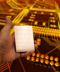 Hand holding a single FR4 PCB laminate from Fifteen Pack FR4 Copper Clad Blank PCB Laminate 70 By 100 By 1.5mm Single Sided Circuit Board.