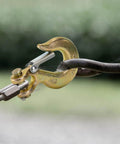 Close-up of a Five Sixteenth Inch Clevis Slip Hook with Latch, Forged G70 Steel, used with chain, for truck and trailer winch, yellow zinc finish.