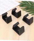 Four Pack Sturdy Chair Clips For Rattan Furniture on wooden surface with leaves