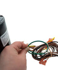 Hand holding wiring and label of HVAC Condenser Motor 1/3 HP Single Phase 208 230V 1075 RPM Replacement For Air Conditioning Unit