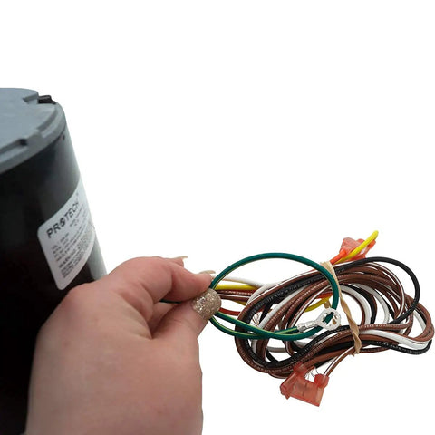Hand holding wiring and label of HVAC Condenser Motor 1/3 HP Single Phase 208 230V 1075 RPM Replacement For Air Conditioning Unit
