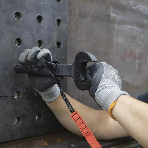 Worker using the Workhorse Construction Spud Wrench With Tether Hole Made In USA 1-1/4 Inch Opening for bolt alignment on steel frame.