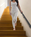 Rock Solid Wall Mounted Stair Handrail Crafted From Premium Black Stainless Steel, shown on indoor steps with user.