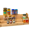 Expandable 3 Tier Bamboo Spice Rack And Kitchen Cabinet Organizer Fits Standard Jars Horizontally with jars and spices displayed.
